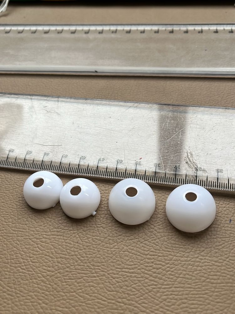 Four White Spherical Beads with Holes