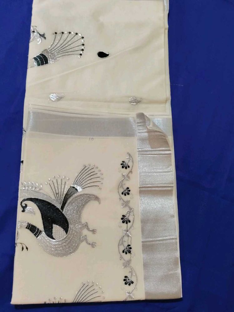 Elegant Cream Saree with Peacock Design