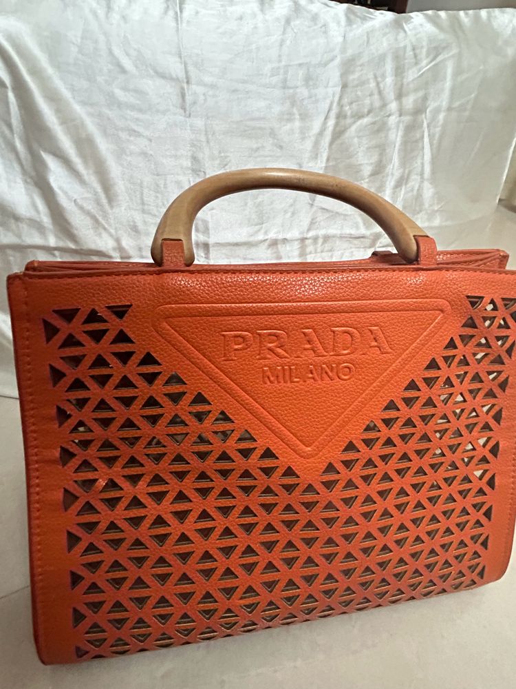 An orange Prada Bag