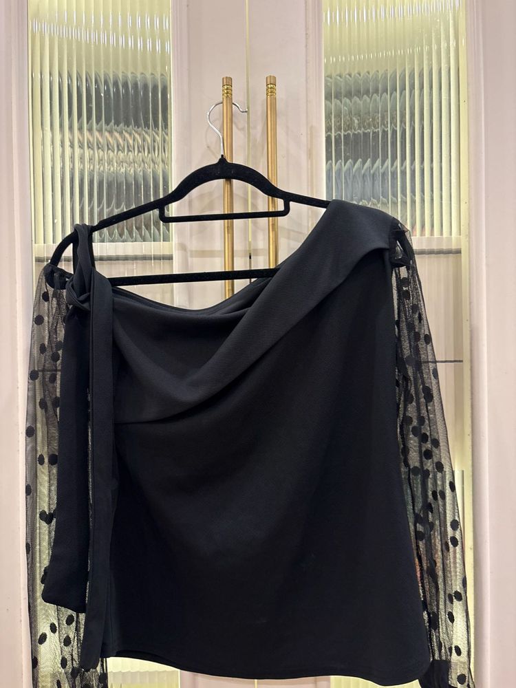 Chic Black Top with Polka Dot Sleeves