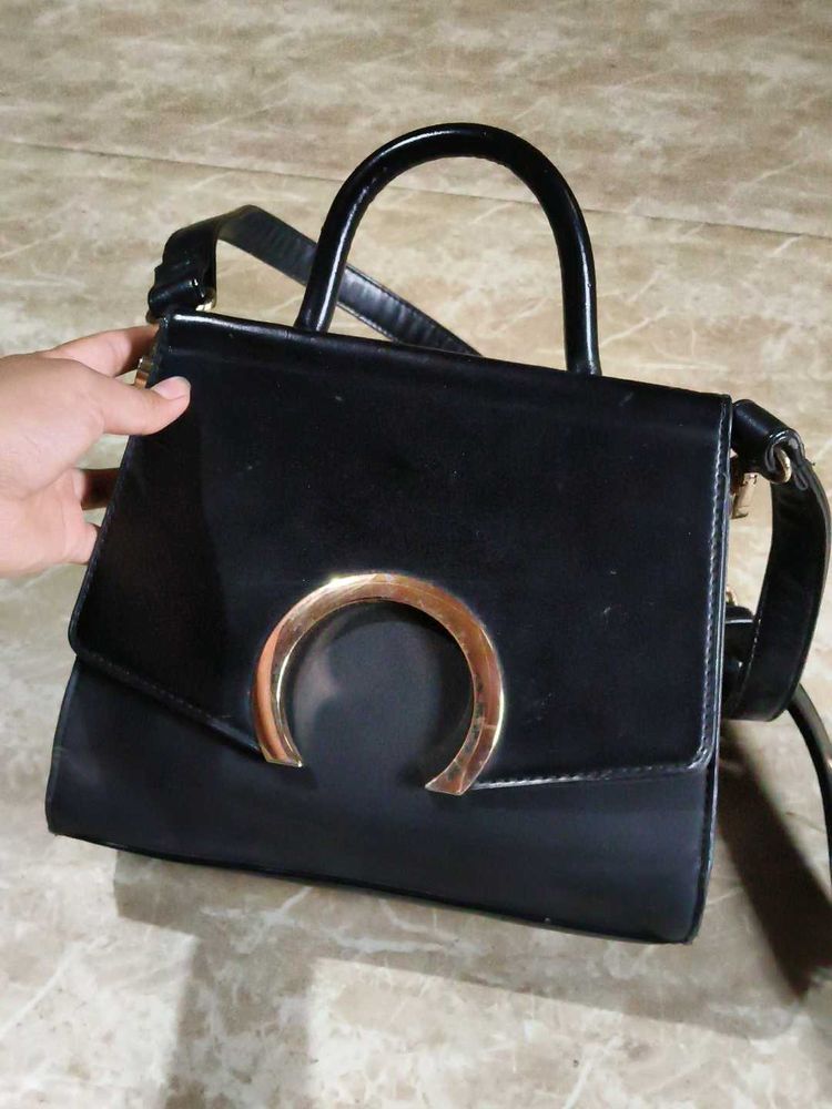 Chic Black Handbag with Gold Accent