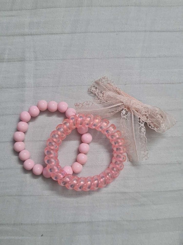 Two coquette lana coded bracelets