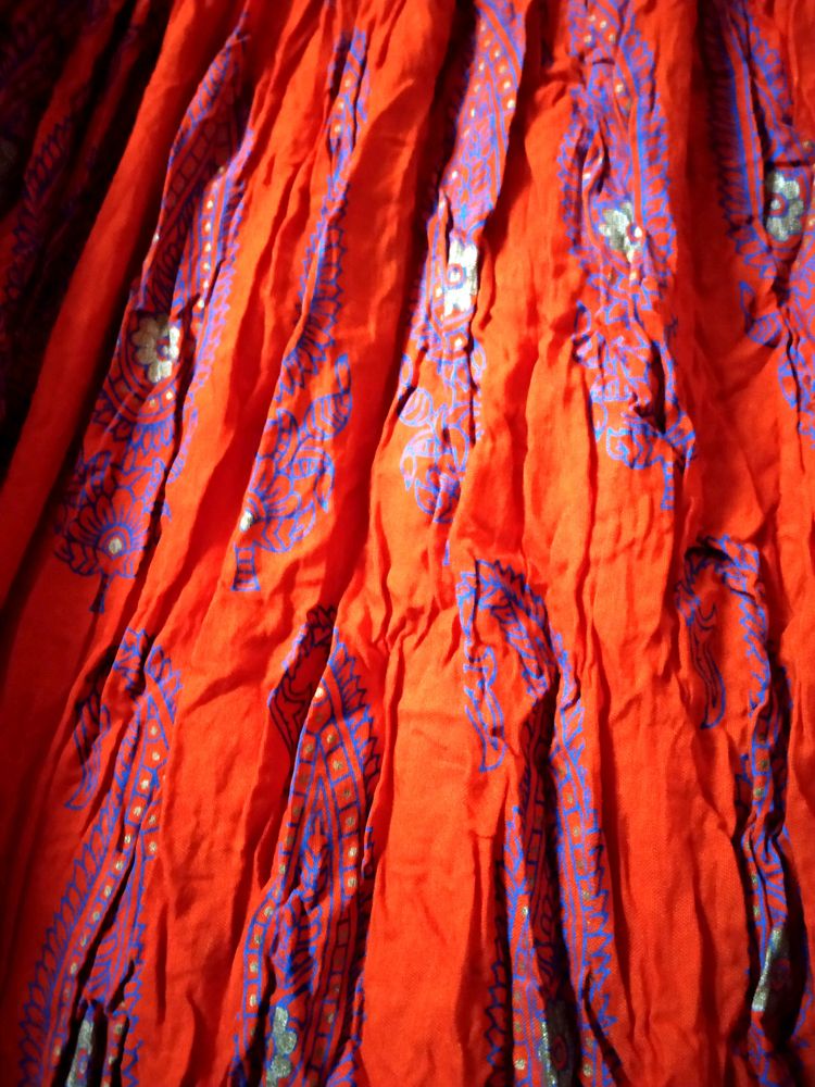 Ethnic skirt, deep Orange colour with blue print.