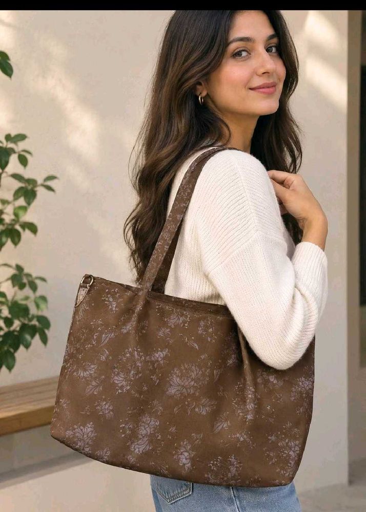 Cute shoulder bag with self color floral print.