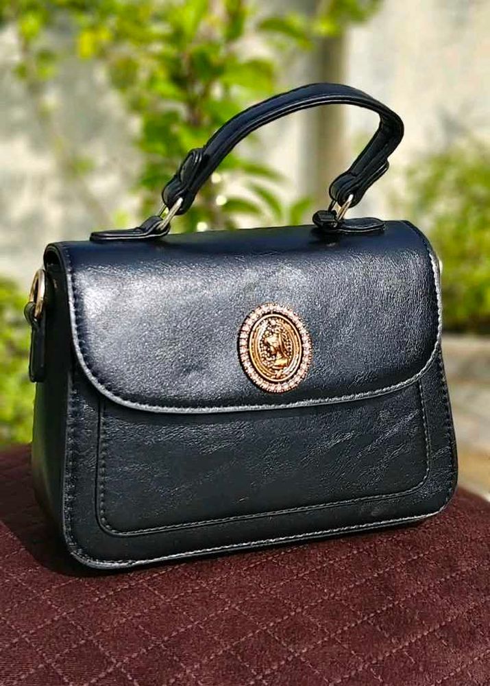 Chic Black Handbag with Gold Emblem