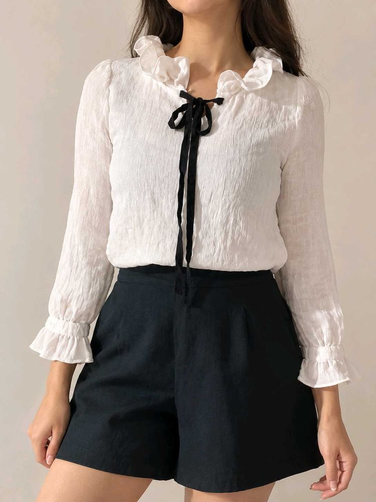 Chic White Ruffled Blouse with Black Bow