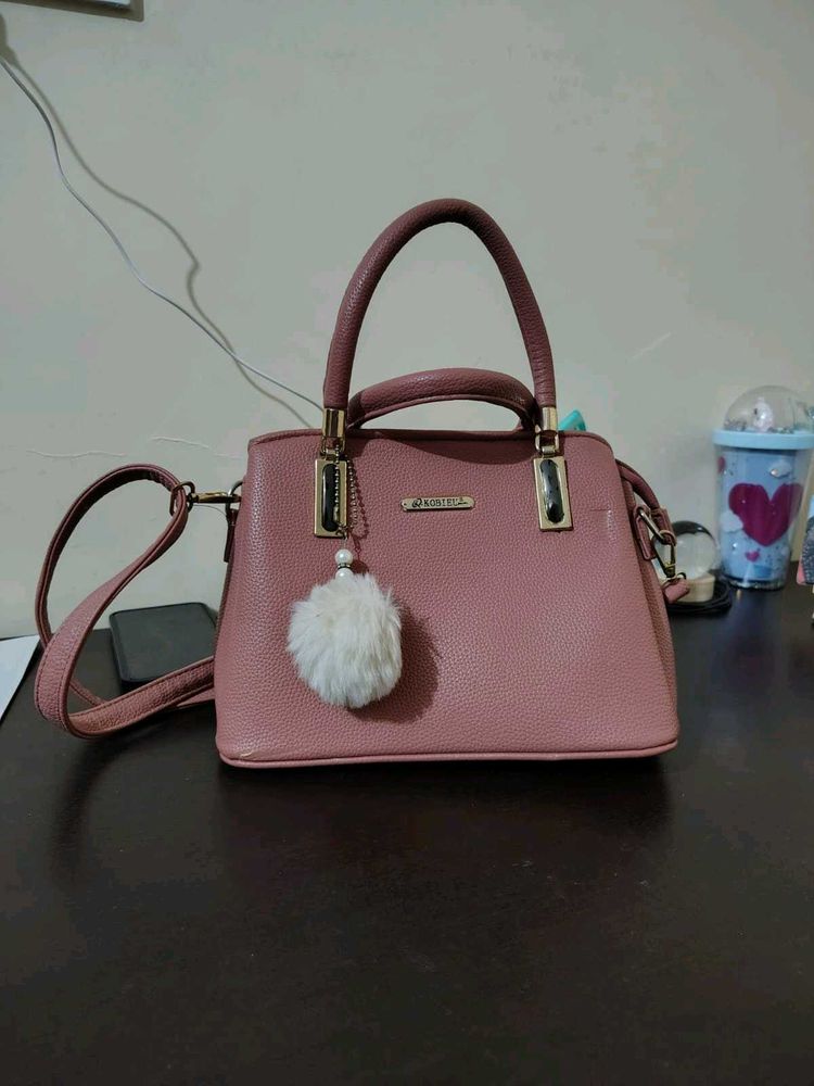 Stylish Pink Textured Handbag with Charm