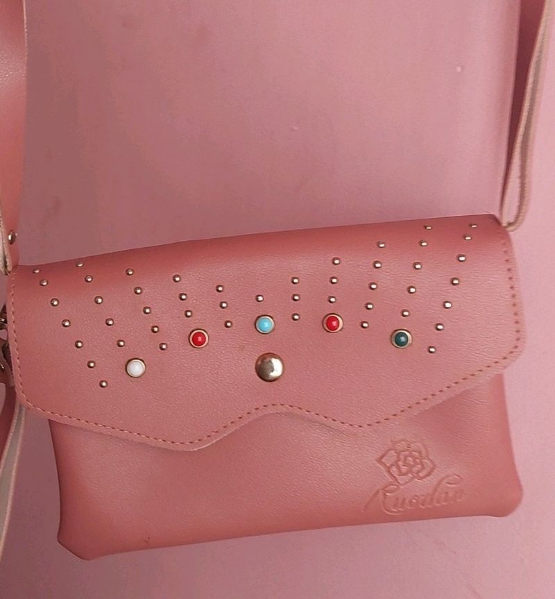 Peach Colour Sling Bag With 2 zips Can Carry Mobile ,wallet Cards And Make Up Items.