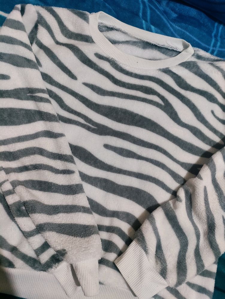 White Velvet Sweater With Black Stripes On It