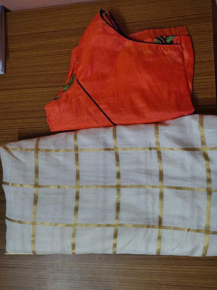 Cream saree with orange blouse