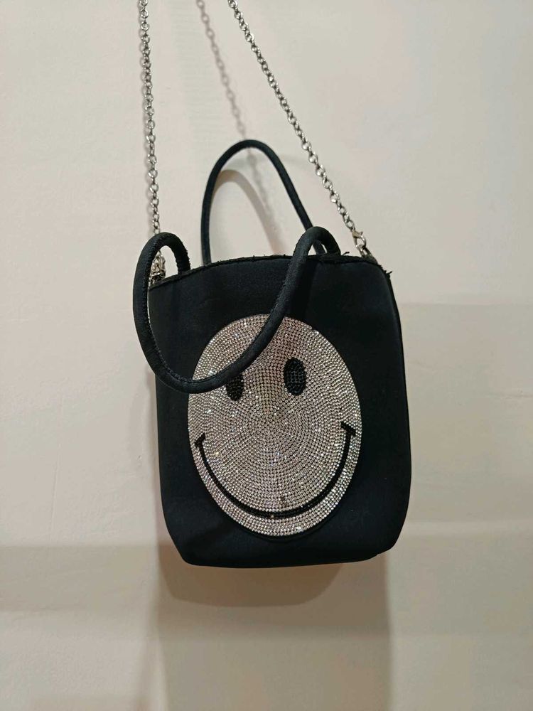 Rhinestone studded smiley face crossbody bag