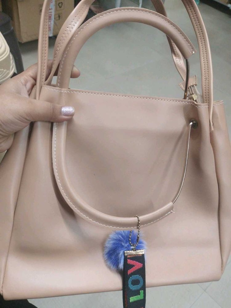 Stylish Beige Handbag with Pom-Pom Charm