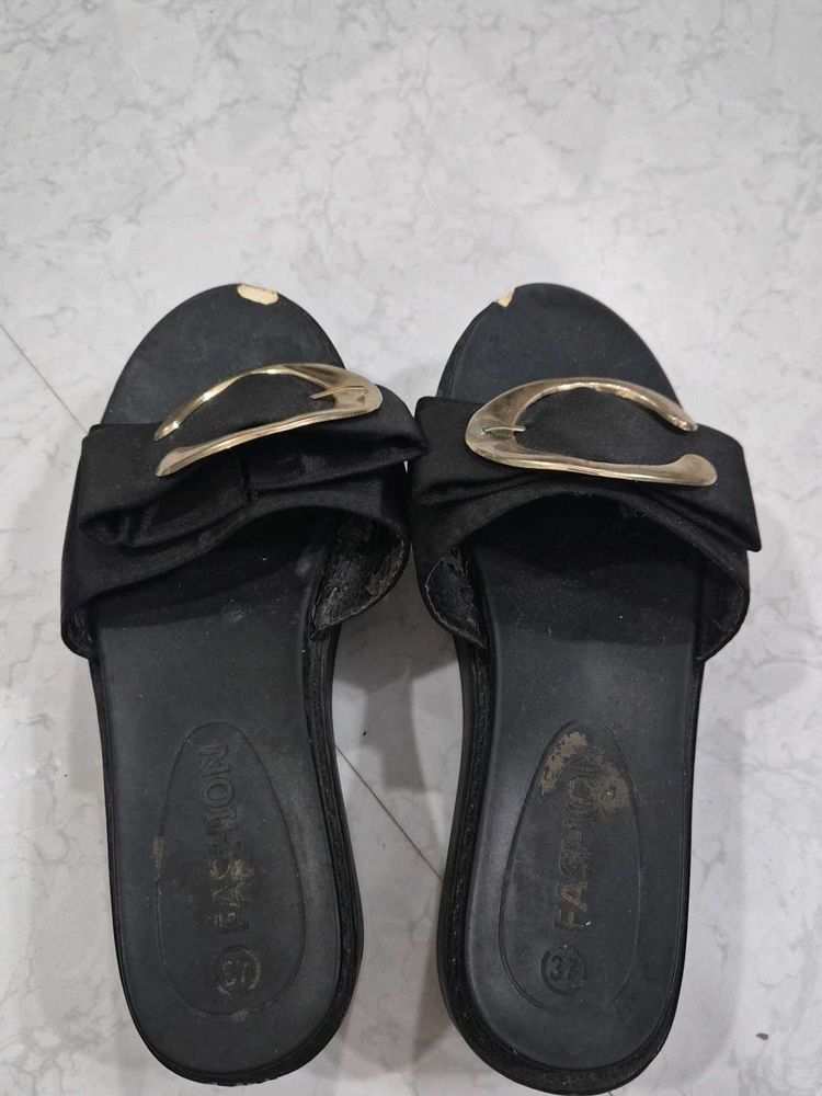 Stylish Black Slip-On Sandals with Gold Accent