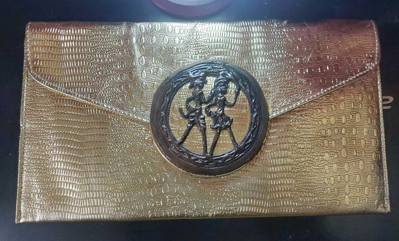 Beautiful golden Clutch with a bronze buckle