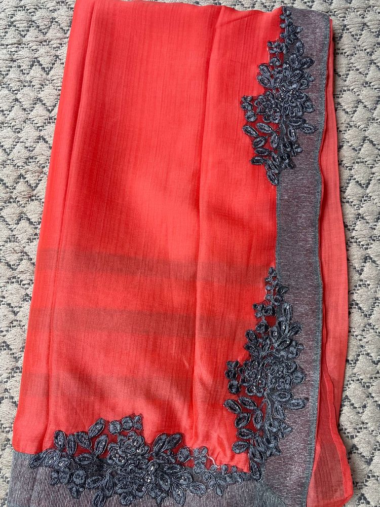 Vibrant Coral Saree with Embellished Border