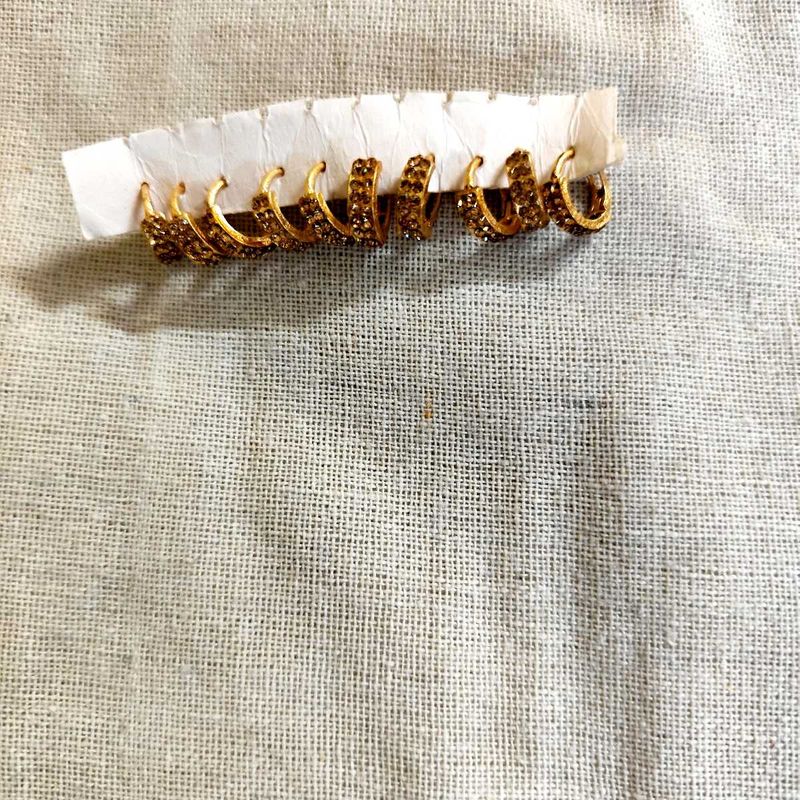 Set of 5 pair golden stone stdded huggie hoops.