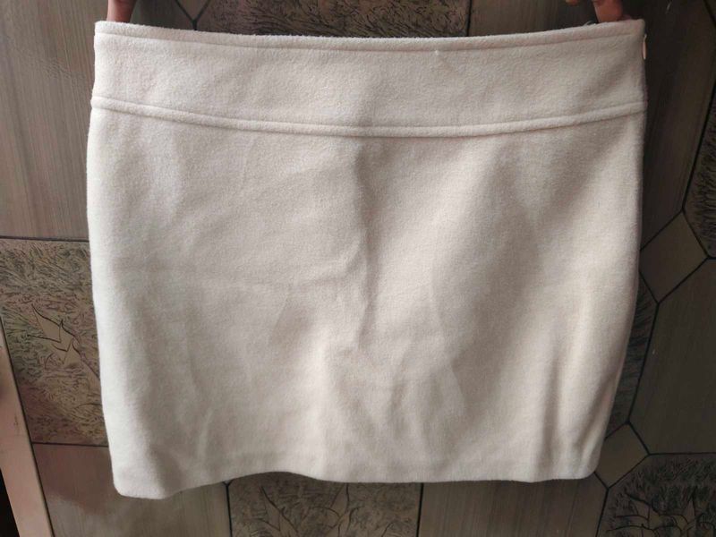 cream colour short skirt.