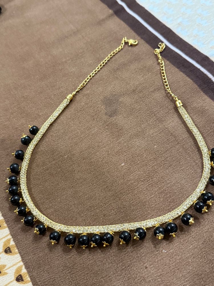 Elegant Gold Necklace with Black Beads