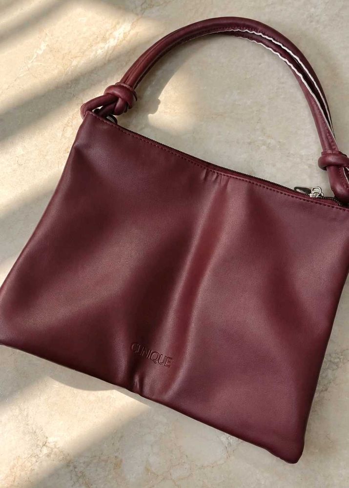 Clinique burgundy Leather Bag.
