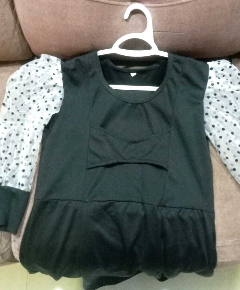 Chic Black Top with Polka Dot Sleeves