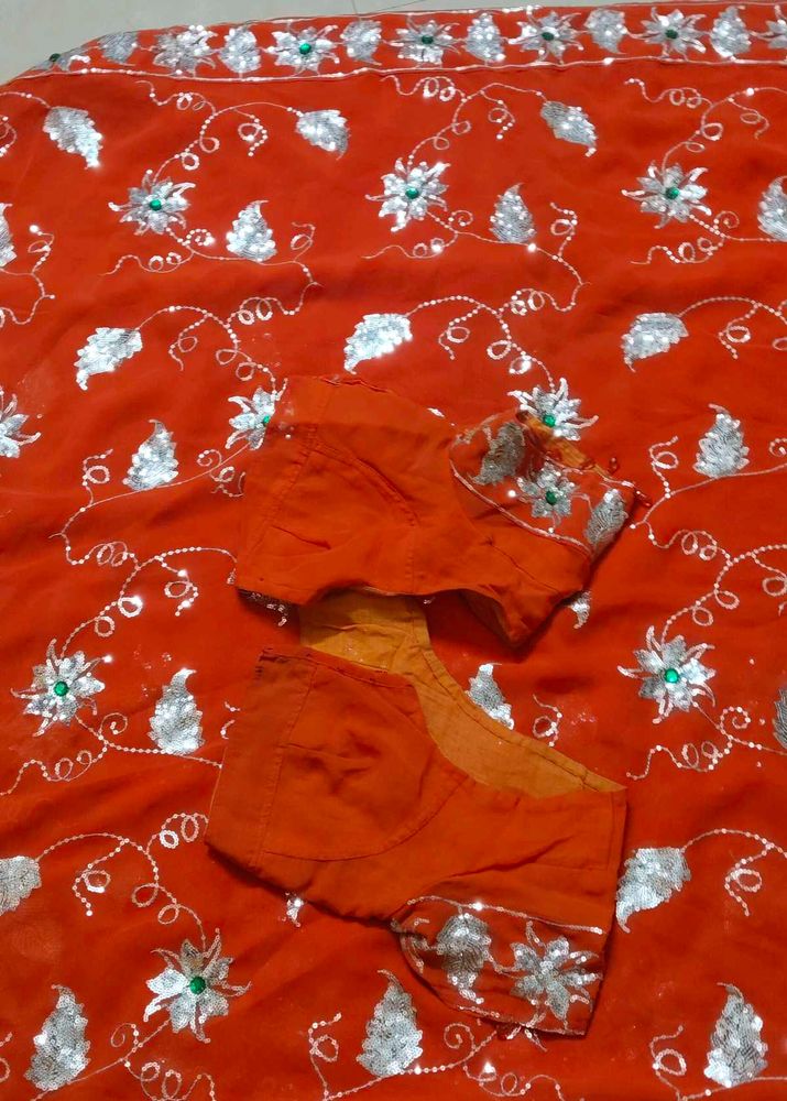 Elegant Orange Saree with Silver Embellishments