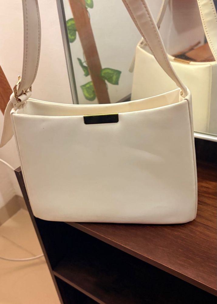 White Handbag With A Golden Buckle