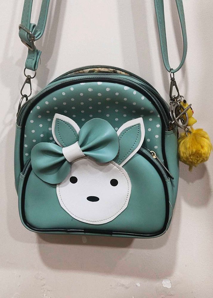 Cute Teal Crossbody Bag with Charm and keychain.