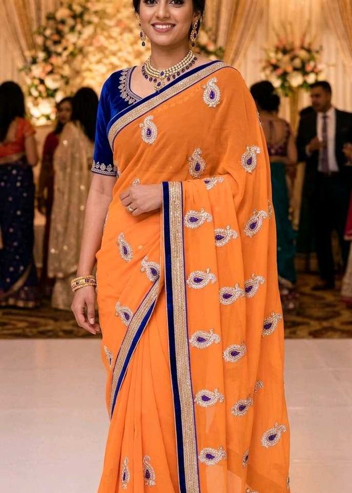Orange Saree with Blue Velvet Blouse