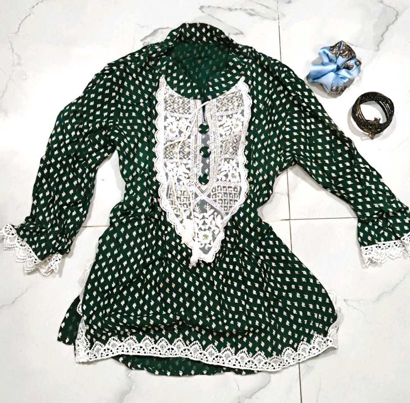 A beautiful dark green short kurti with embellish