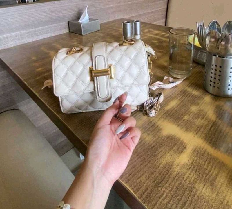 Beige sling bag along with chain slin