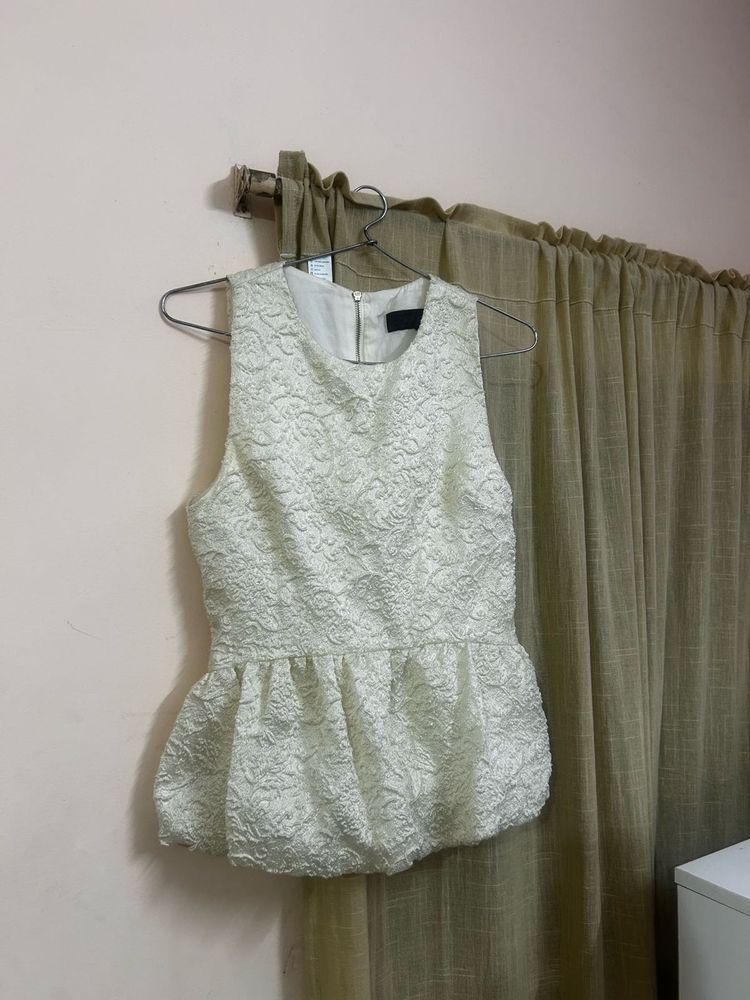 The ivory peplum top