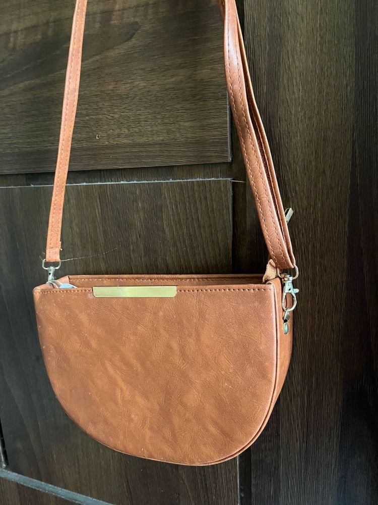 Tan brown half moon sling bag