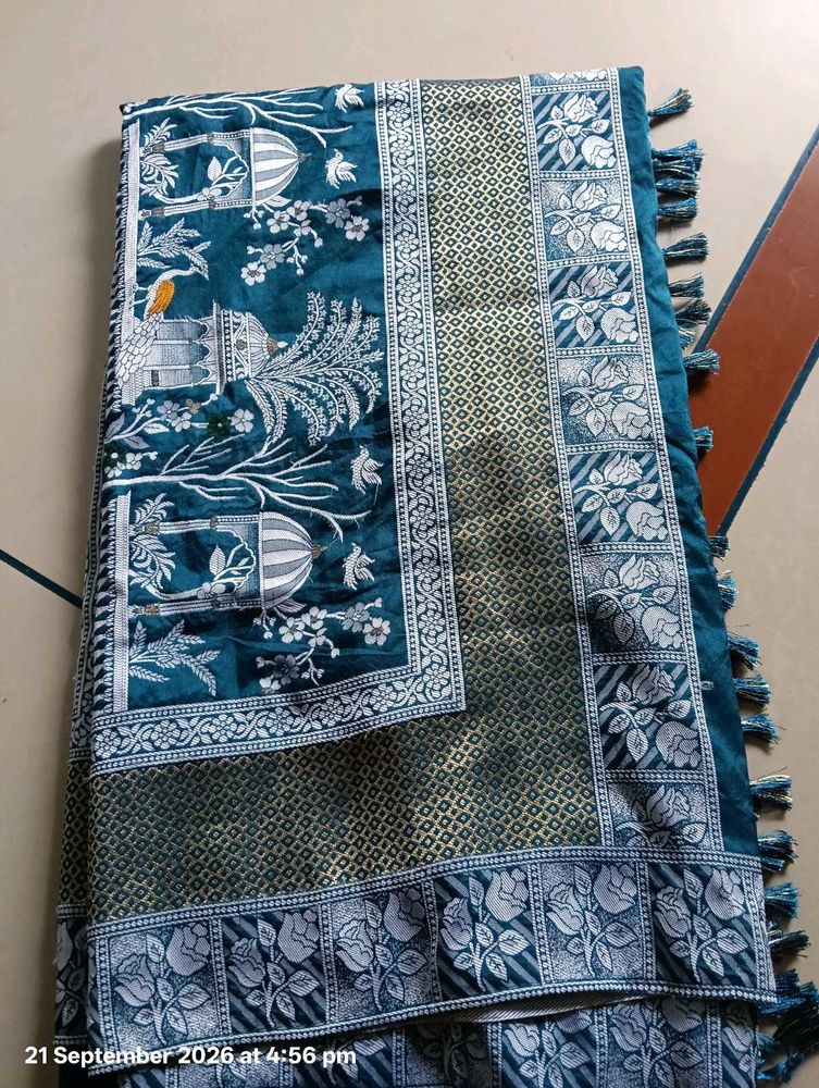 Elegant Teal Saree with Intricate Designs
