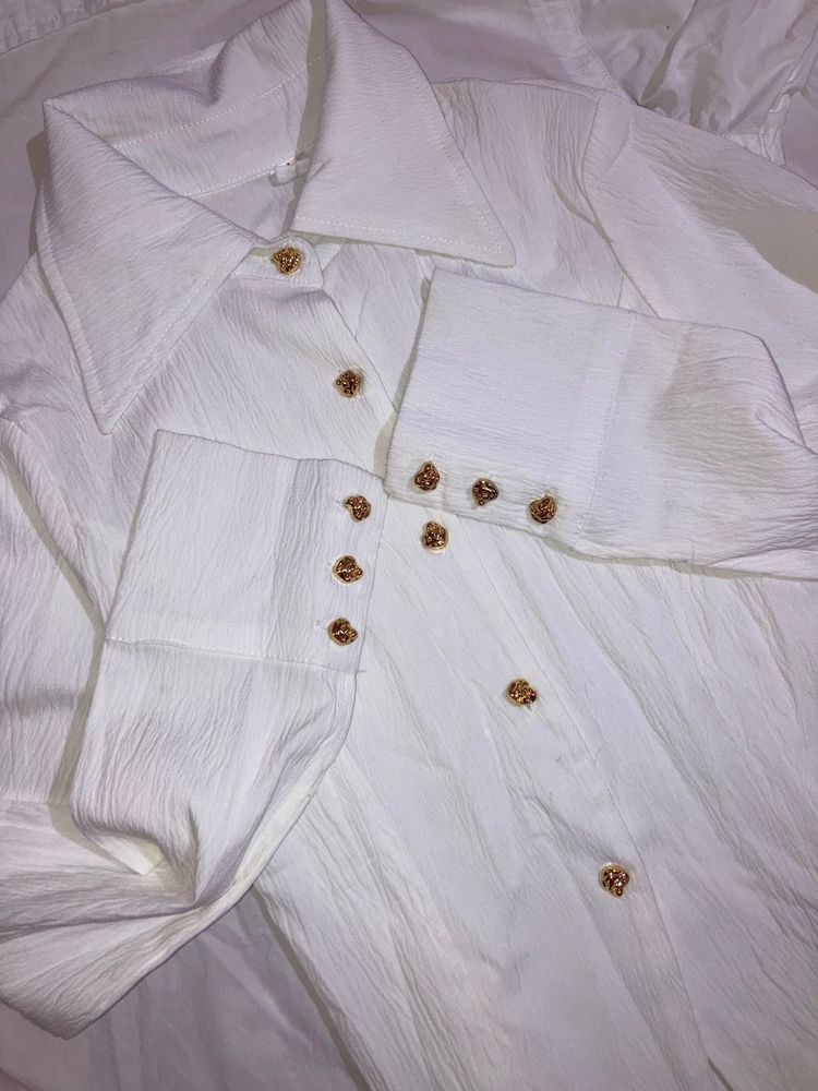 white shirt with gold button details