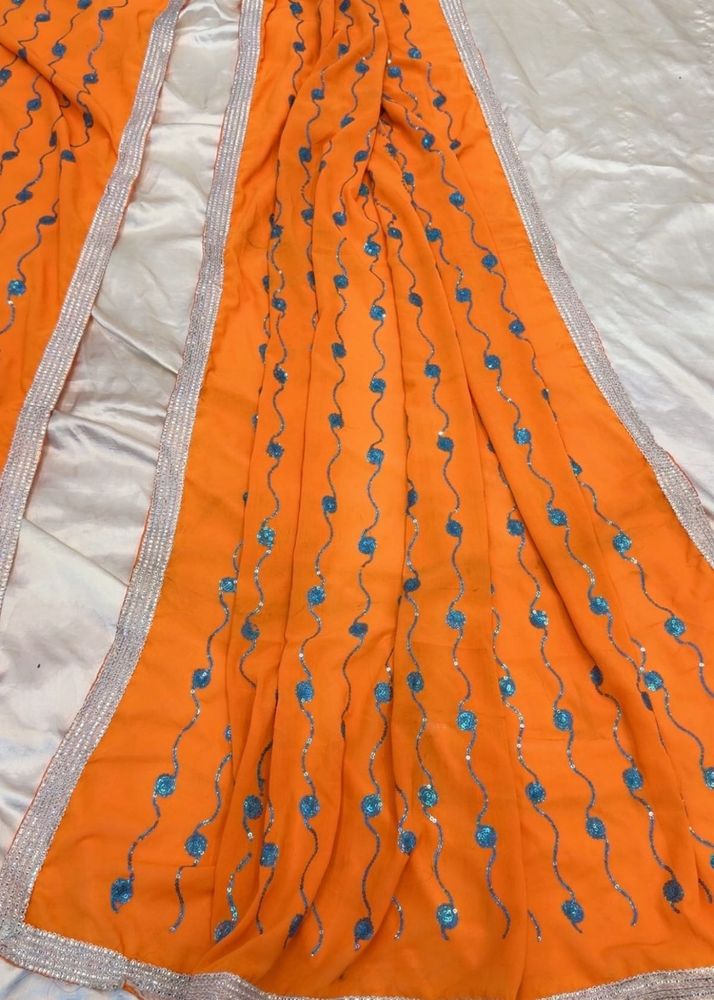 Vibrant Orange Saree with Blue Embellishments