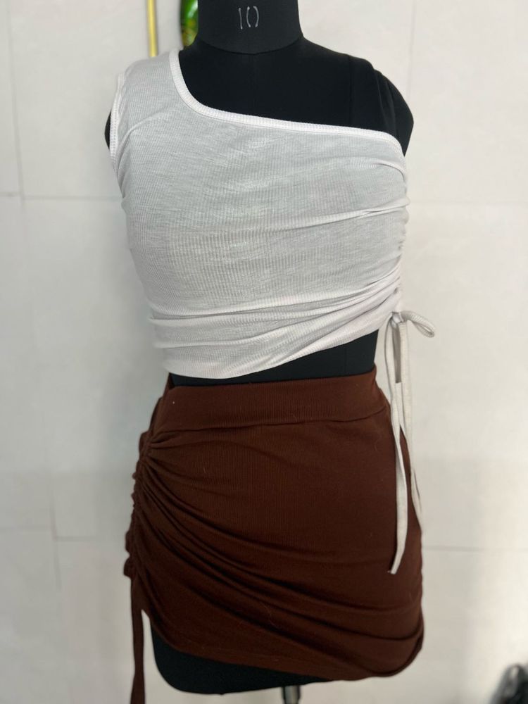 white top and brown skirt