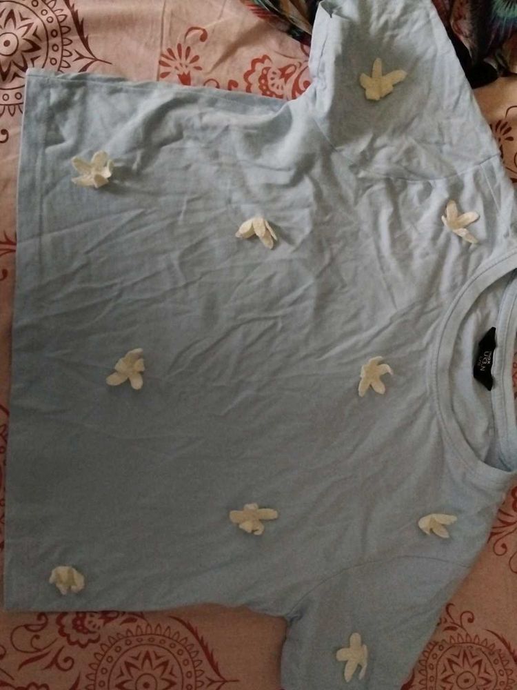 Light Blue T-Shirt with Flower Embellishments