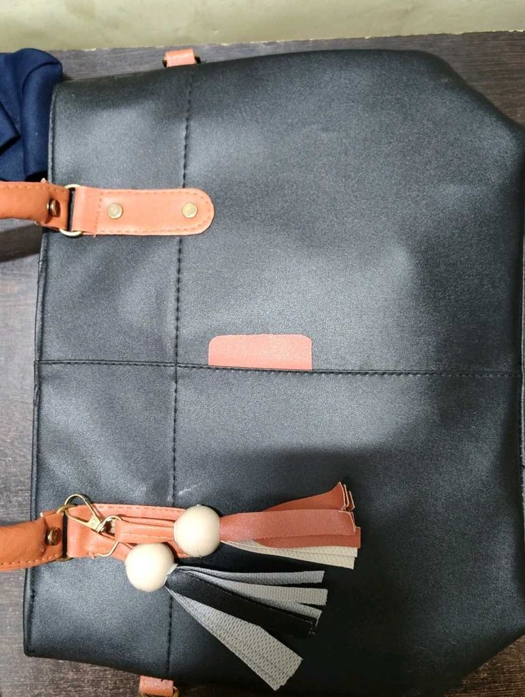 Chic Black Tote Bag with Tassel Accent