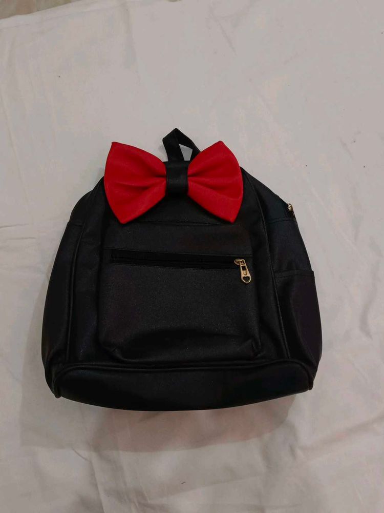 Black Backpack with Red Bow