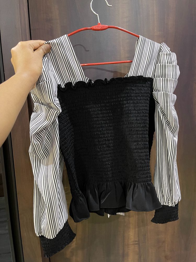 Black top with puffed sleeves and bow at the back