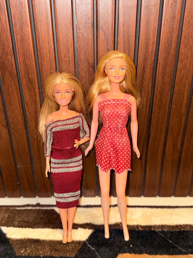 Two barbie dolls