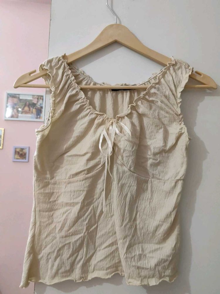 Cream ruched tie-front sleeveless top