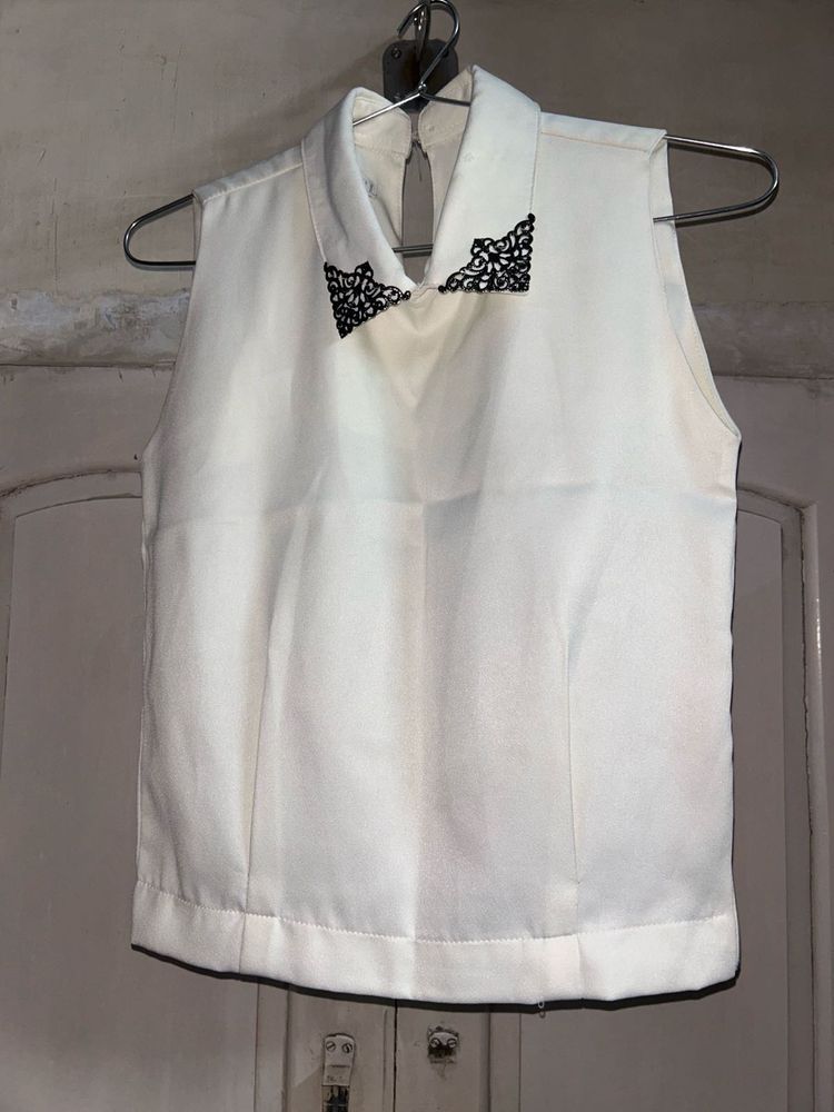 Sleeveless White Top with Black Lace Detail