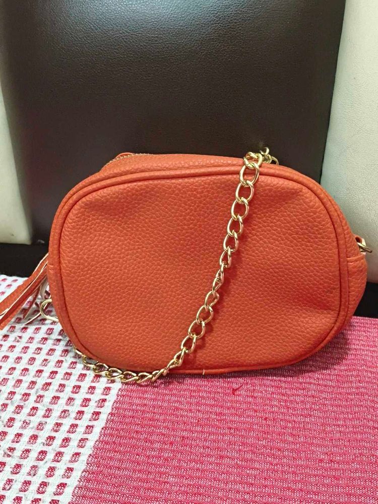 Chic Orange Crossbody Bag with Gold Chain
