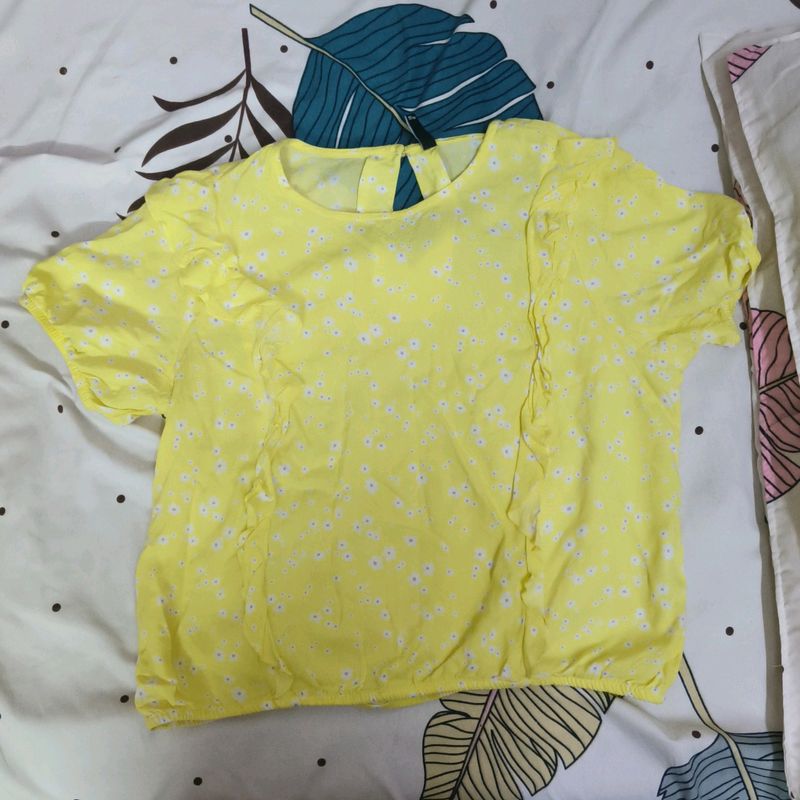 A Yellow Colour Top With Frills In The Front