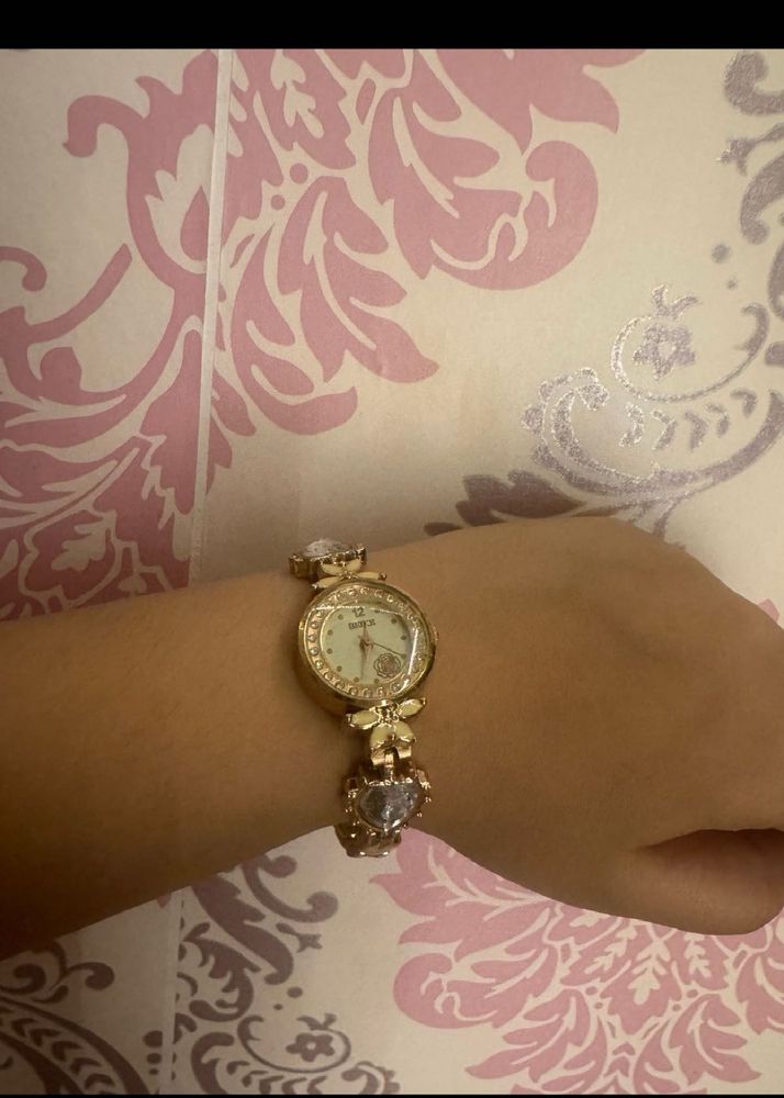 Elegant Gold Tone Watch with Charm