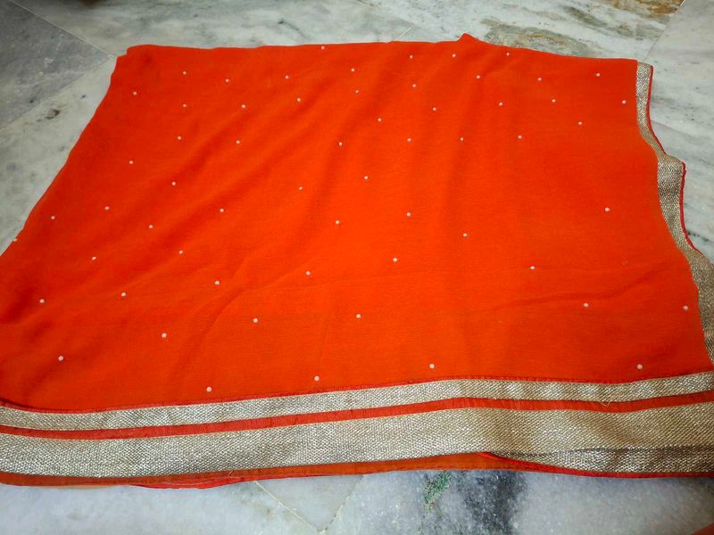 Vibrant Orange Saree with Pearl Embellishments